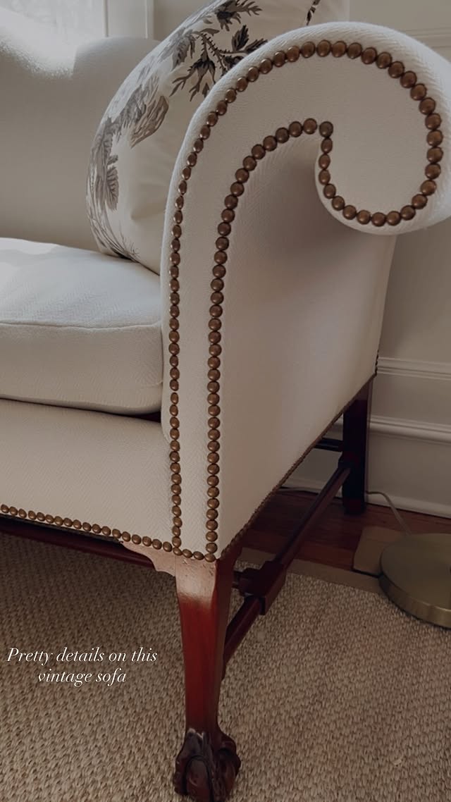 Nailhead trim detail on a vintage camelback sofa